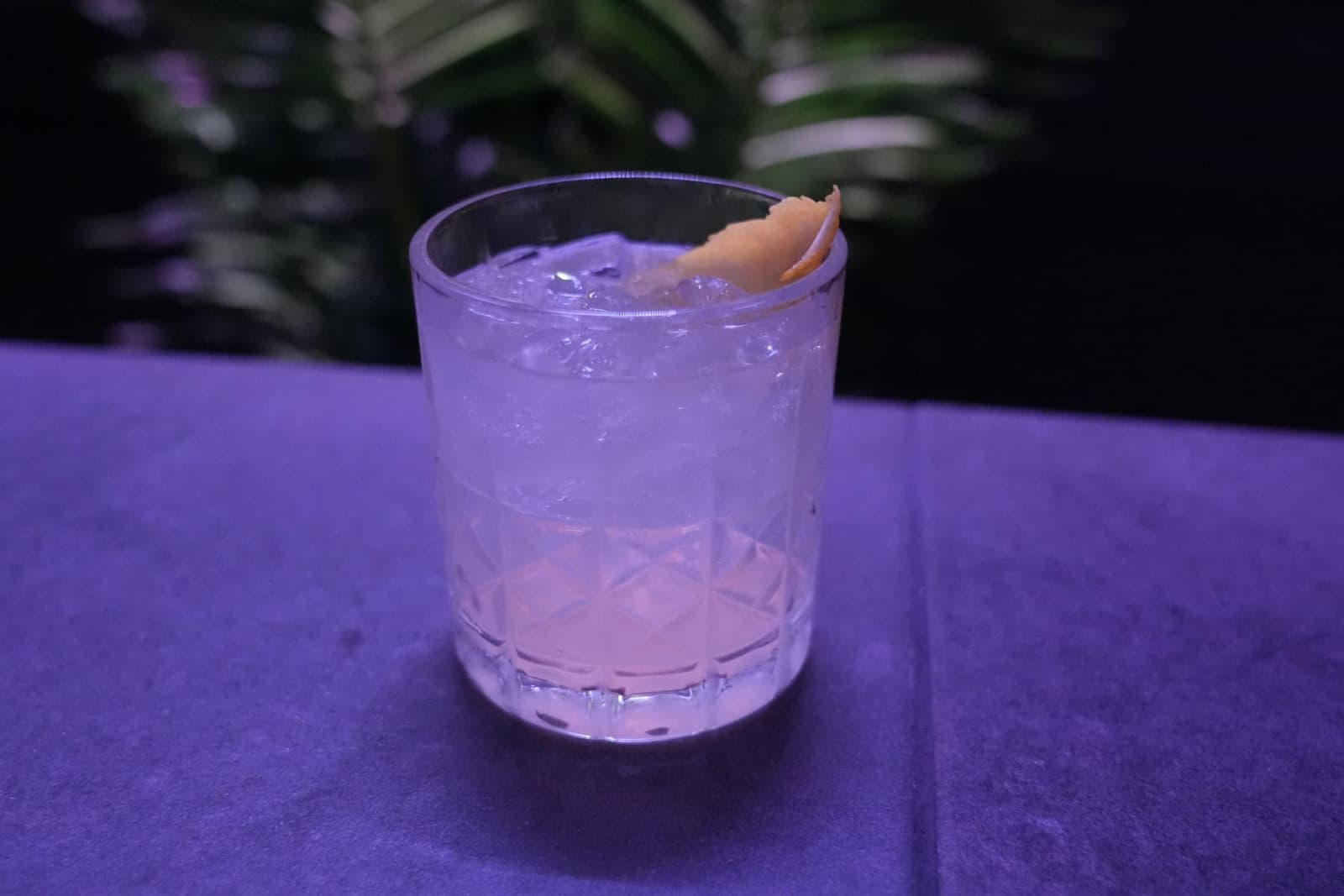The Meridian cocktail under purple lounge lighting