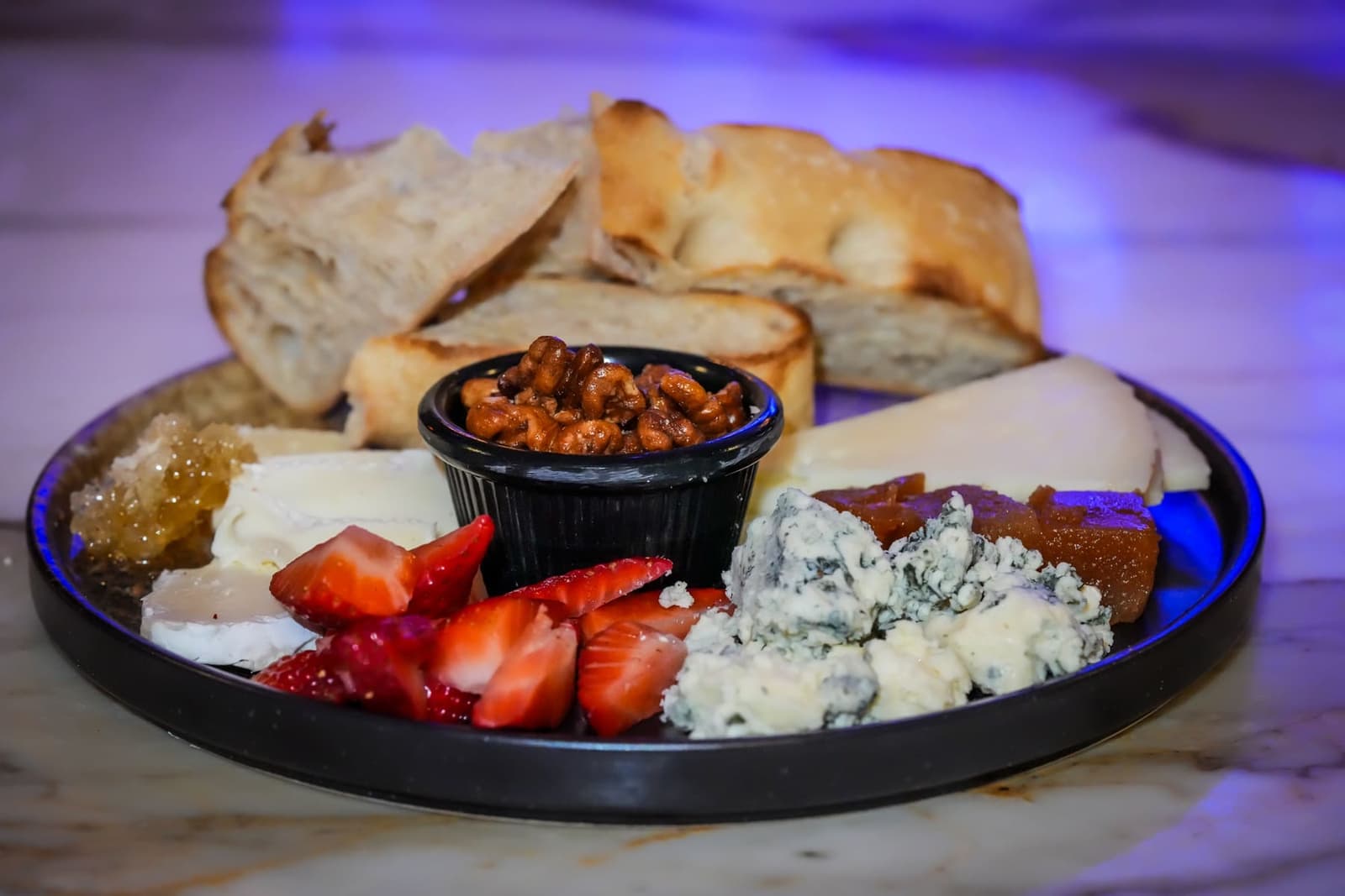 Family-style board with prosciutto, honeycomb, and seasonal cheeses