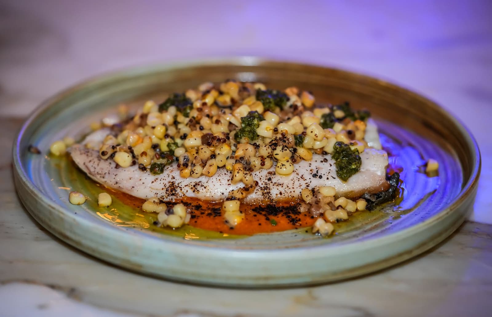 Plated course — branzino over charred-corn quinoa